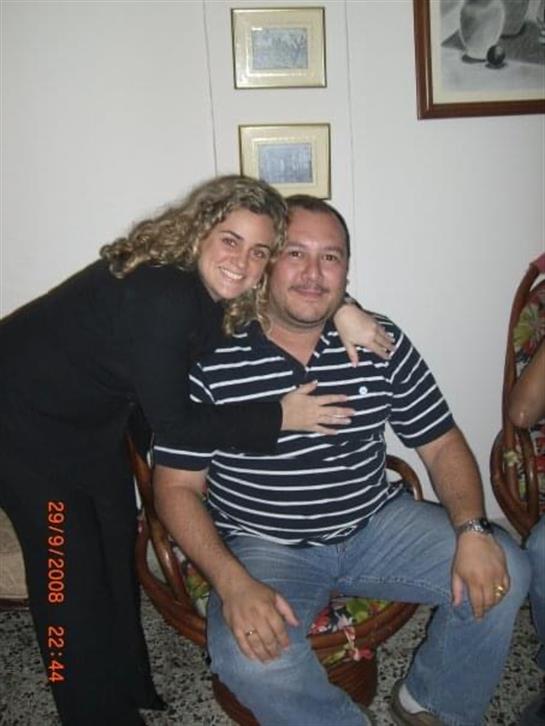 Friends enjoy a joyful evening together, sharing laughter and warm embraces in a cozy setting.