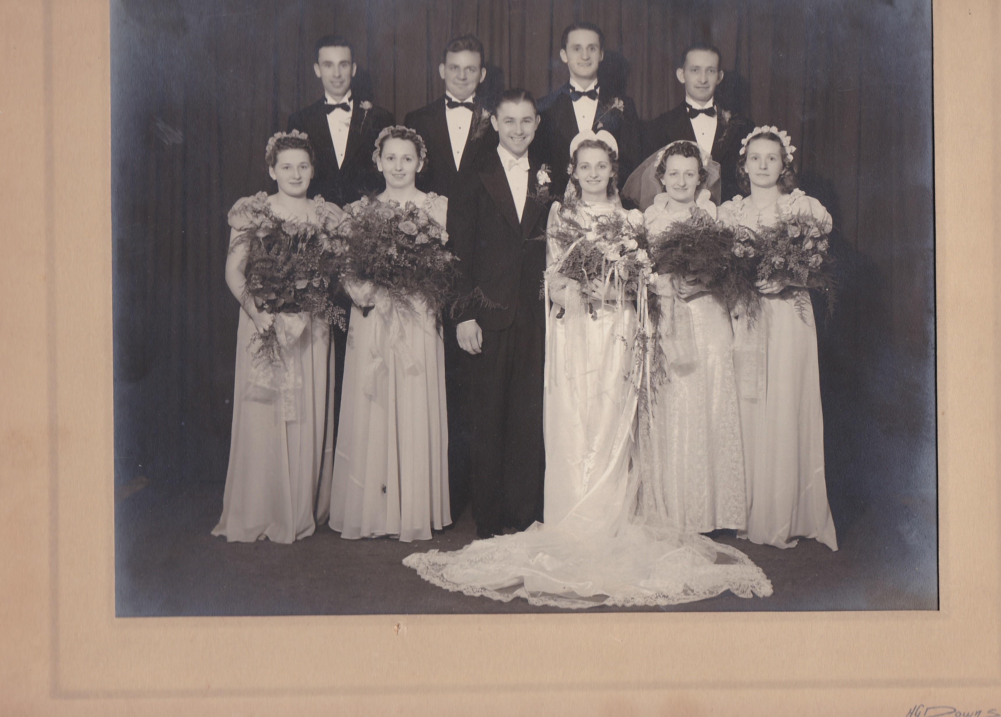 This joyful gathering features a bridal party in formal clothing, celebrating love and togetherness.