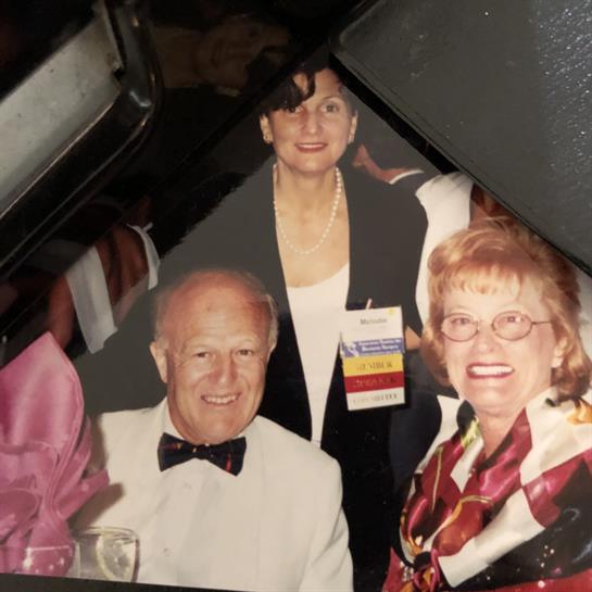 Guests are enjoying a joyful moment during a formal event, showcasing laughter and camaraderie.