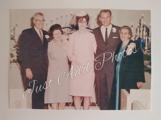 Family members elegantly dressed, smiling and celebrating a special occasion together.