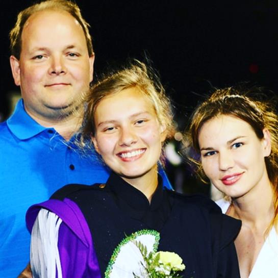 Family celebrates together at a graduation ceremony, cherishing a special moment.