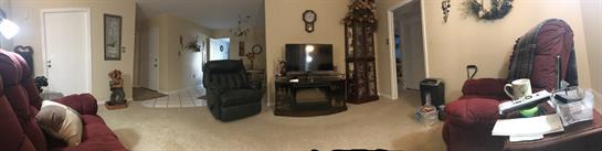 Cozy living room with a TV, comfy chairs, and decor that invites relaxation.