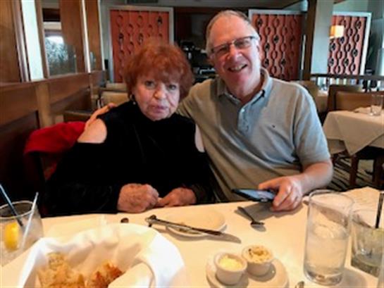 Lunch is being enjoyed by a couple in a cozy restaurant setting, revealing warmth and companionship.