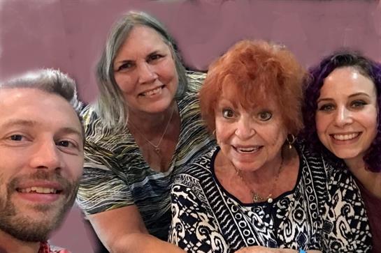 Four friends share smiles and laughter at a gathering, creating lasting memories.