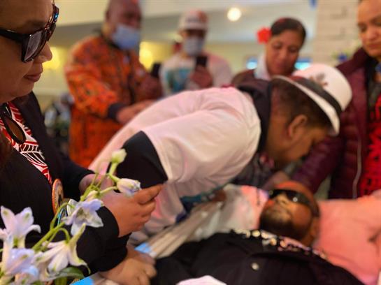 Family and friends gather around a hospitalized individual, sharing emotional moments and farewells.