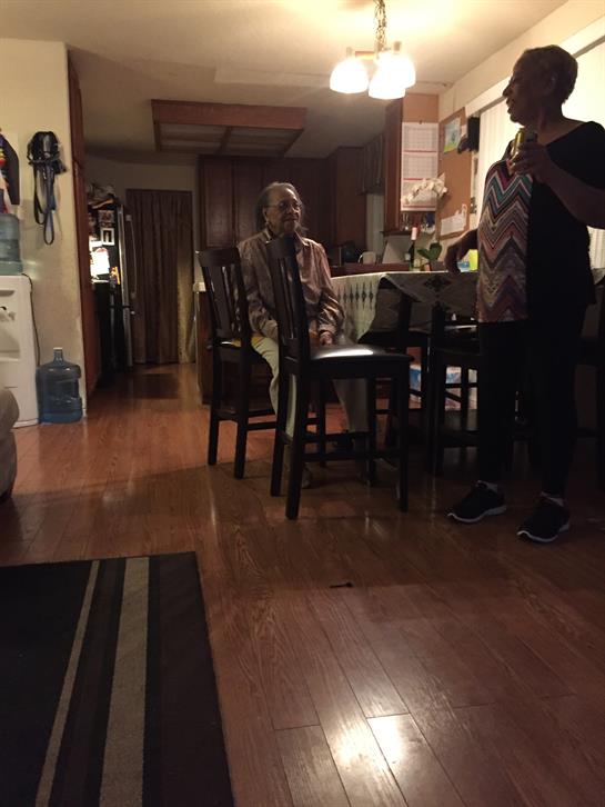 Family members enjoy a relaxed evening in a cozy kitchen, sharing stories and creating memories.