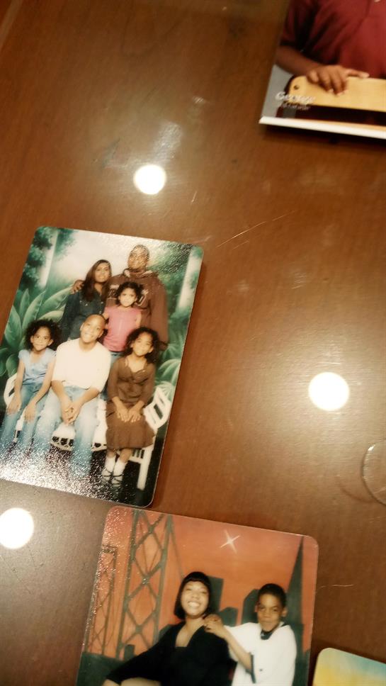 A warm gathering features a family portrait with children and adults smiling together.