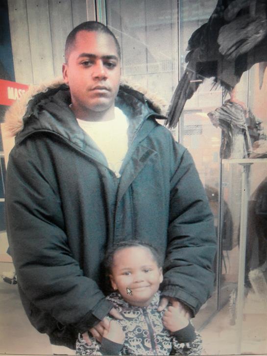 A father holds his smiling child at an interactive exhibit, showcasing their strong bond and joy.