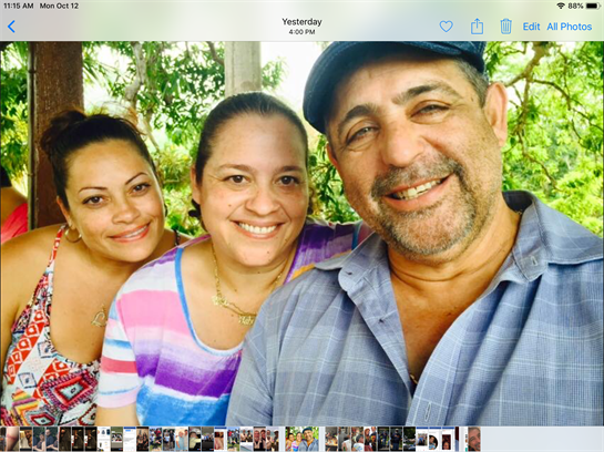 Four friends enjoy a cheerful gathering outdoors surrounded by lush green vegetation.