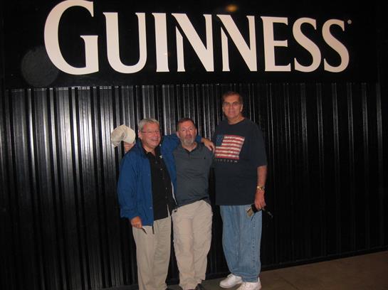 Three friends pose together, smiling and enjoying their time at a brewery in Dublin.