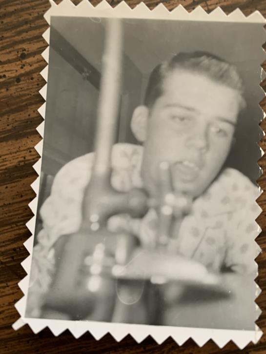 A musician passionately plays the trumpet, capturing the energy of a vibrant bar performance.