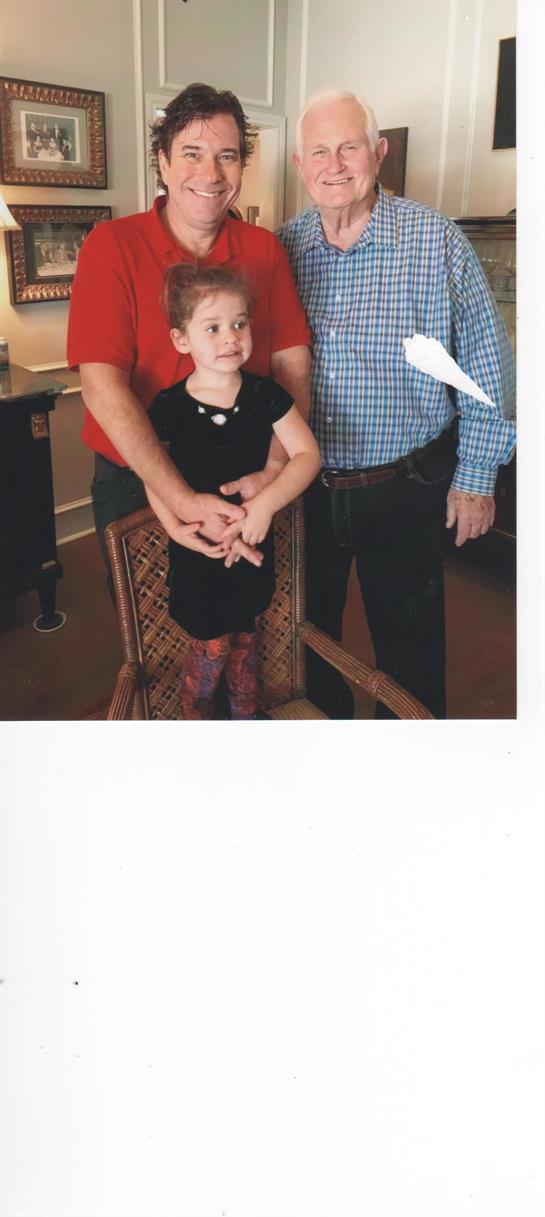 Three family members pose together, showing joy and connection in a warm, inviting atmosphere.