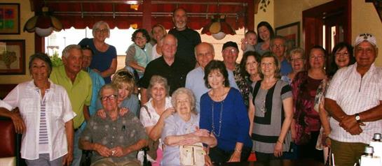 A joyful family celebrates together in a lively restaurant, sharing smiles and stories.