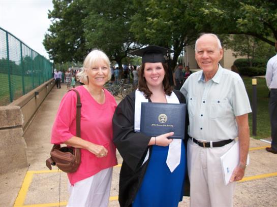Family gathers to celebrate a graduation ceremony on the university campus in joyful moments.