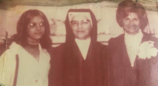 Three individuals gather in a vintage setting, highlighting a moment of connection and tradition.