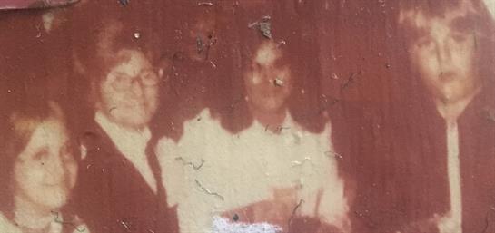 A group of friends enjoy each other's company at a casual event in the late 1970s.