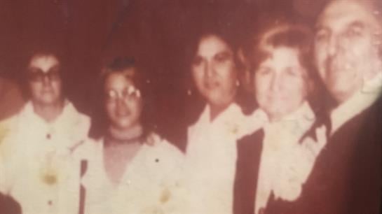 Three friends engage in conversation while enjoying a festive celebration together.