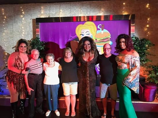 Participants and performers gather for a fun, colorful night of laughter and entertainment.