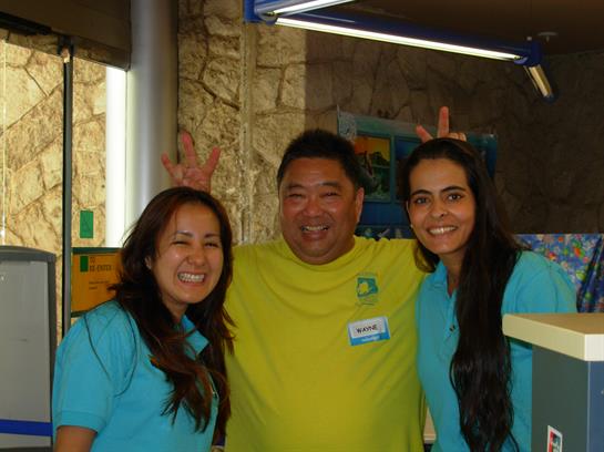 Three friends pose happily outdoors, showing their vibrant spirit at the gathering.