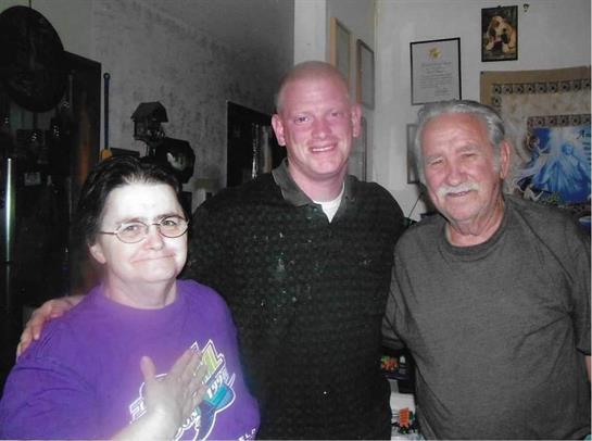 Relatives share smiles and laughter together in a cozy living room during a family gathering.