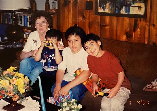Children enjoy games and take photos during a family visit in a warm, inviting living room.