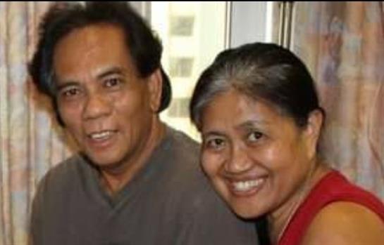 Two friends radiate happiness while enjoying a lively conversation in a warm setting.