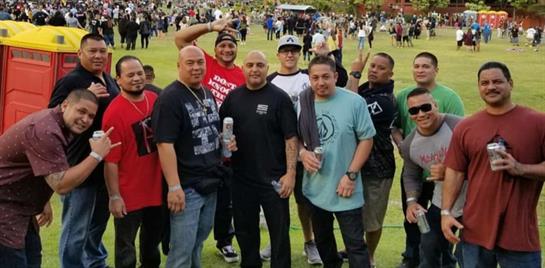 Friends enjoy an outdoor gathering, showcasing camaraderie and celebration in a park setting.