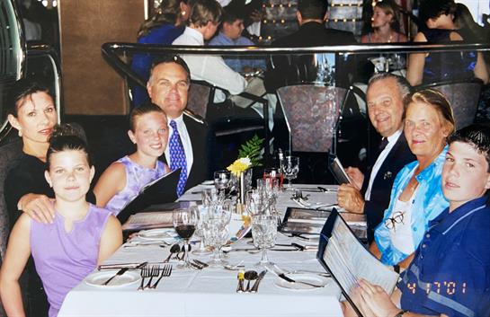 Family gathered around a table, examining menus and enjoying each other's company during dinner.