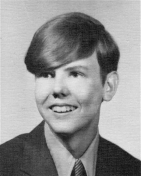Young male student smiles confidently for a school portrait taken in the 1970s.