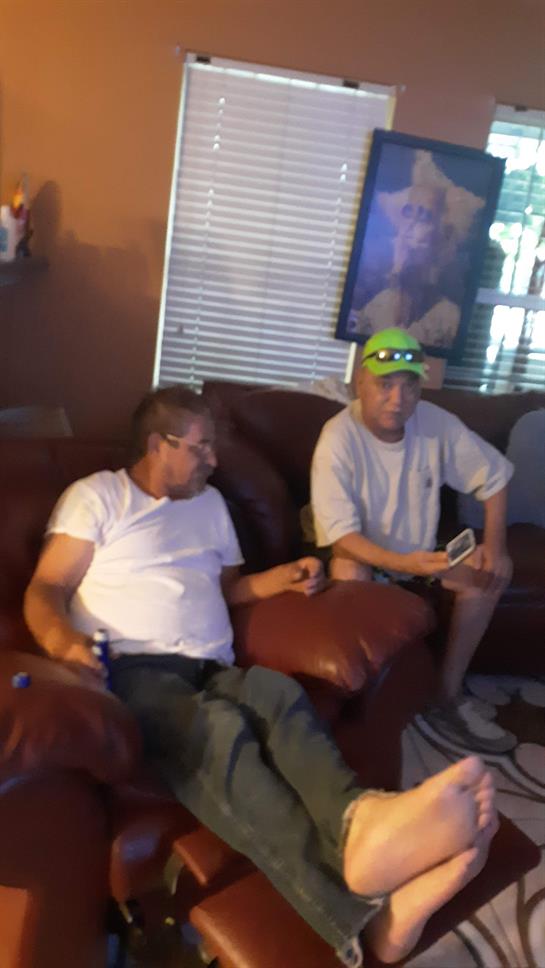 Friends enjoy each other's company while sitting comfortably in a relaxed living room setting.