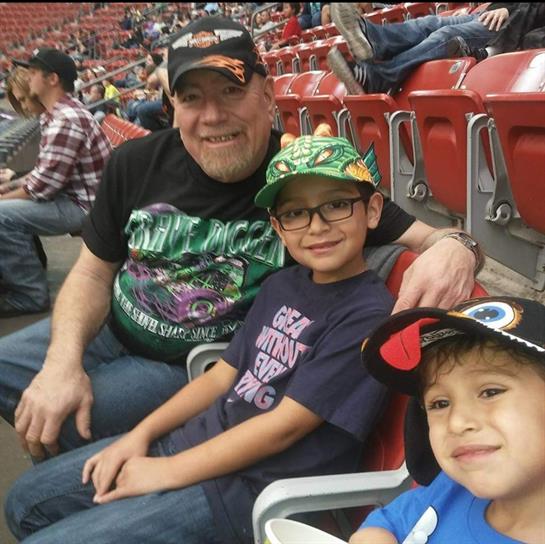 Family members are gathered, smiling and having fun at a sports event in a stadium.