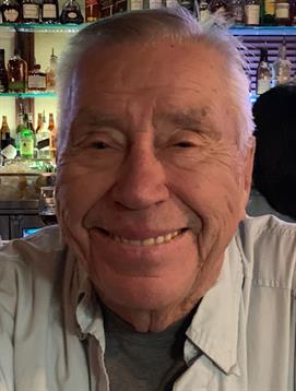 Elderly man enjoys a moment at the bar, smiling warmly amid lively surroundings and colorful lights.