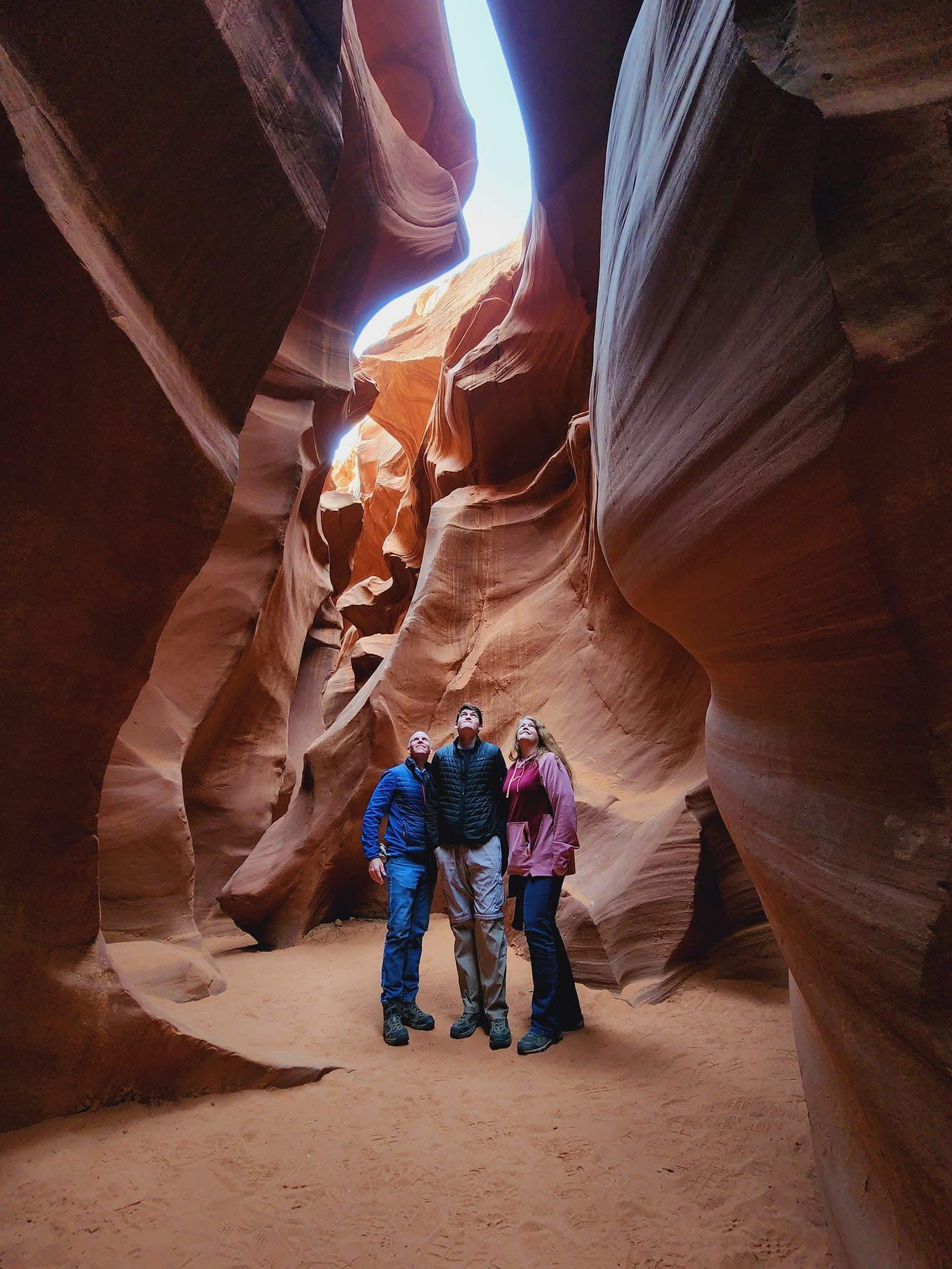Friends explore a stunning canyon filled with unique rock formations and natural light.