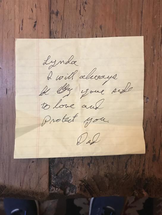 A yellow sticky note reveals a father's promise to love and protect his daughter always.