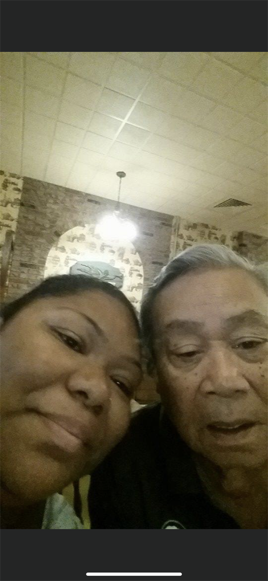 Two family members share a joyful moment at a cozy restaurant during a casual outing.