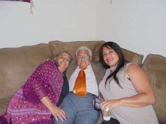 Three family members enjoy a cozy moment on the couch, showcasing love and connection at home.