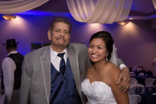 Guests celebrate a happy couple at an elegantly decorated wedding reception.