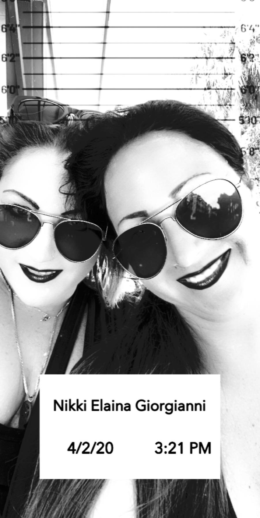 Two friends pose for a cheerful selfie, wearing sunglasses and enjoying a sunny day outdoors.