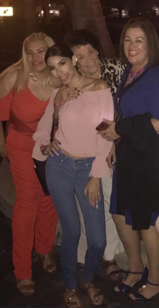 Friends enjoy each other's company at a warm gathering, captured in a lively moment.