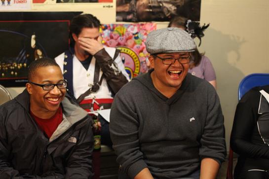 Laughter fills the room as friends enjoy a casual chat at a cultural event, creating memories.