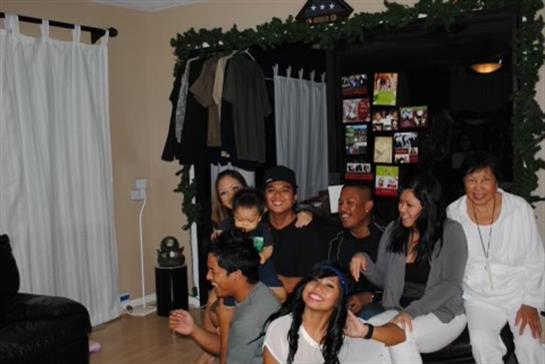 Friends and family gather in a cozy living room, sharing laughter and joy together.