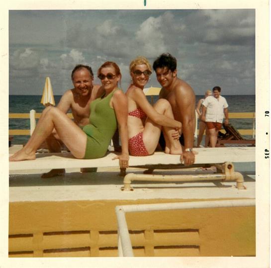 Group of friends relaxing by the poolside, soaking up the sun and enjoying each other's company.