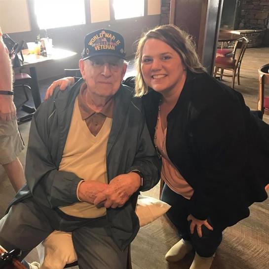 A veteran enjoys quality time with a family member at a restaurant filled with warmth and laughter.