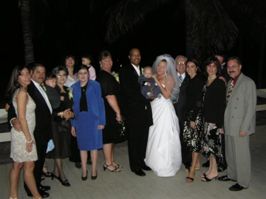 Joyful gathering of family and friends at a wedding celebration during an evening event.