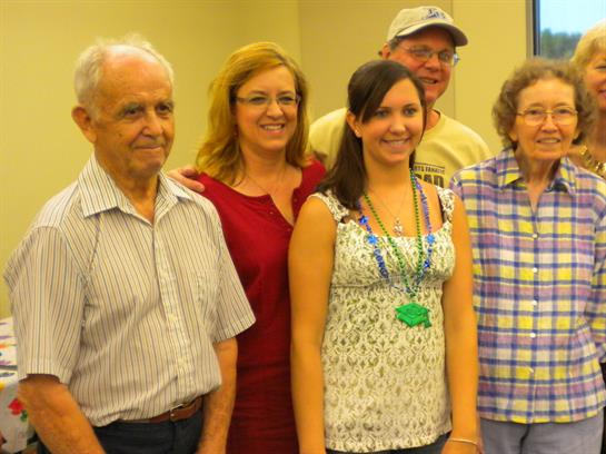 Group of five people smiles together, capturing a moment of joy and connection at an event.