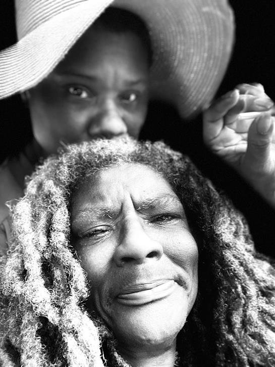 Two women with vibrant personalities enjoy a sunny day together, expressing joy and connection.