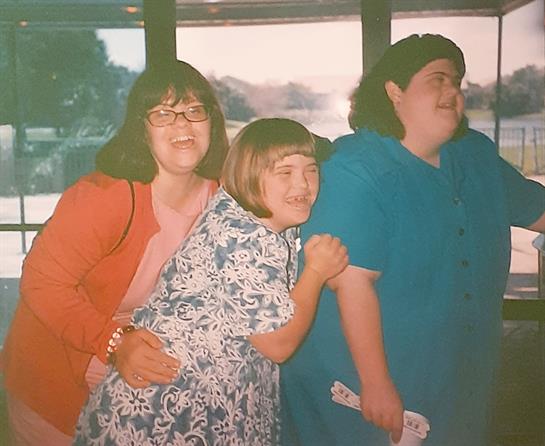 Three friends share laughter and joy during a fun gathering.