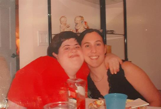 Friends enjoy each other's company at a casual gathering with drinks and snacks shared among them.