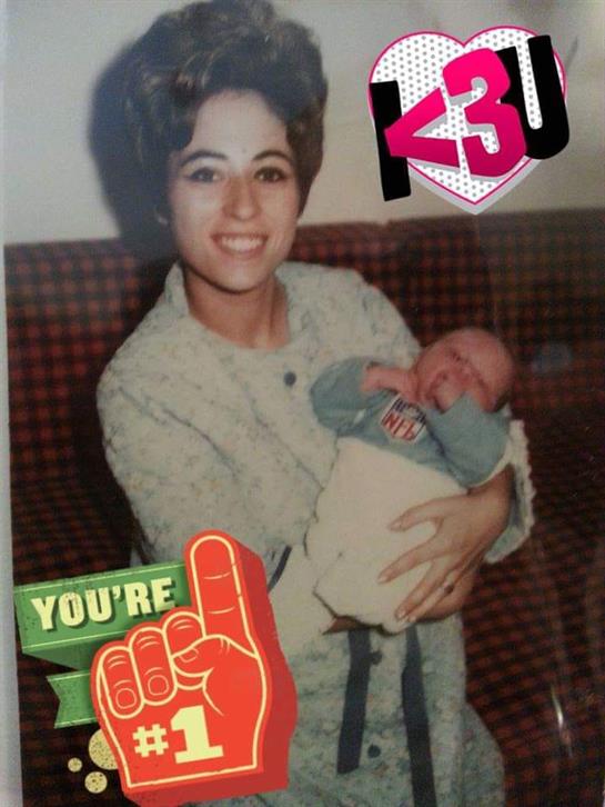 A woman embraces her infant, displaying happiness in a warm, inviting atmosphere at home.