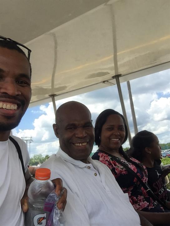 A lively group smiles and relaxes together, enjoying a sunny day of fun and camaraderie.